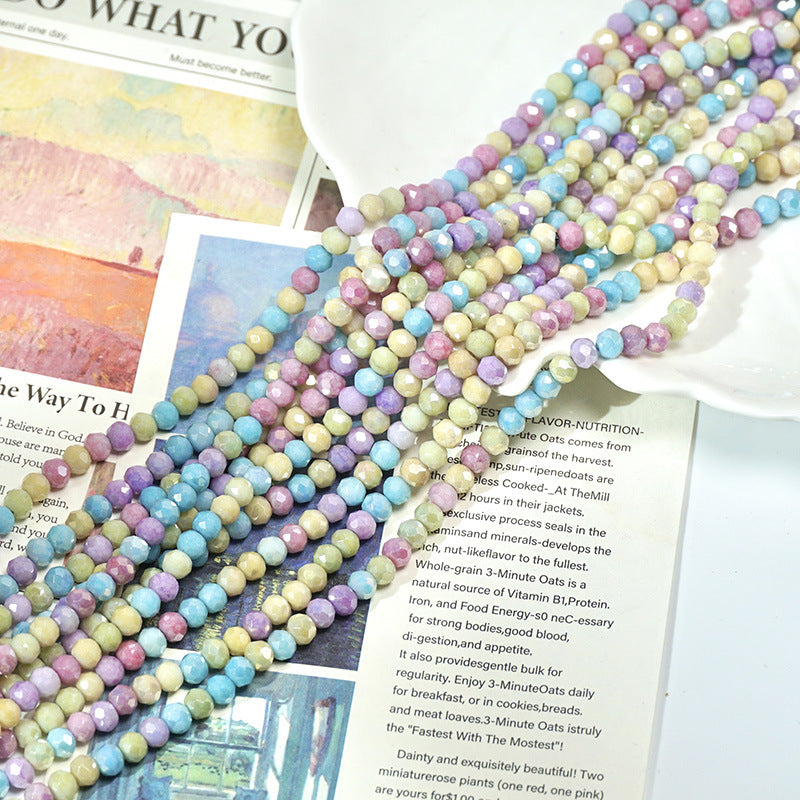 Pastel multicolor faceted porcelain bead strands arranged on open book