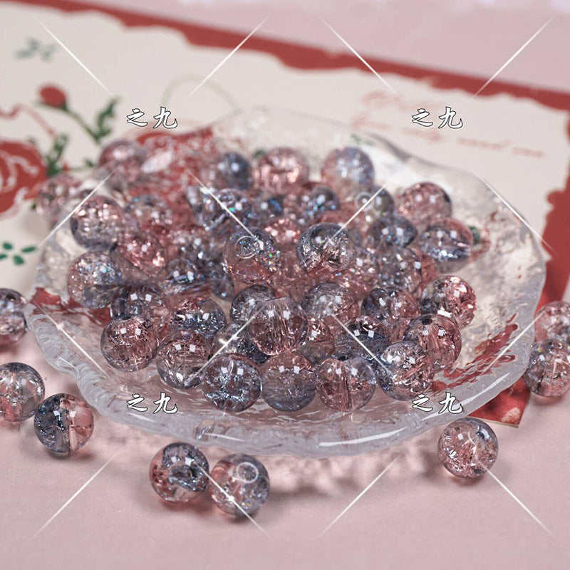 Clear glass beads with pink and silver glitter in a glass dish on pink floral background