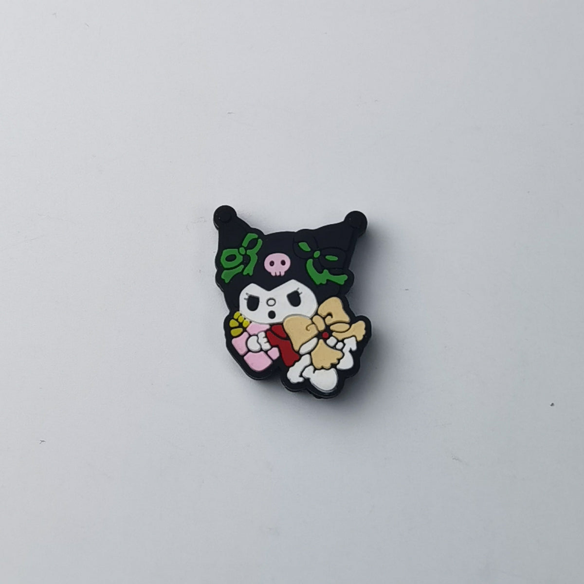 Kuromi silicone focal bead with black hood, green bows and pink skull, holding tan teddy bear