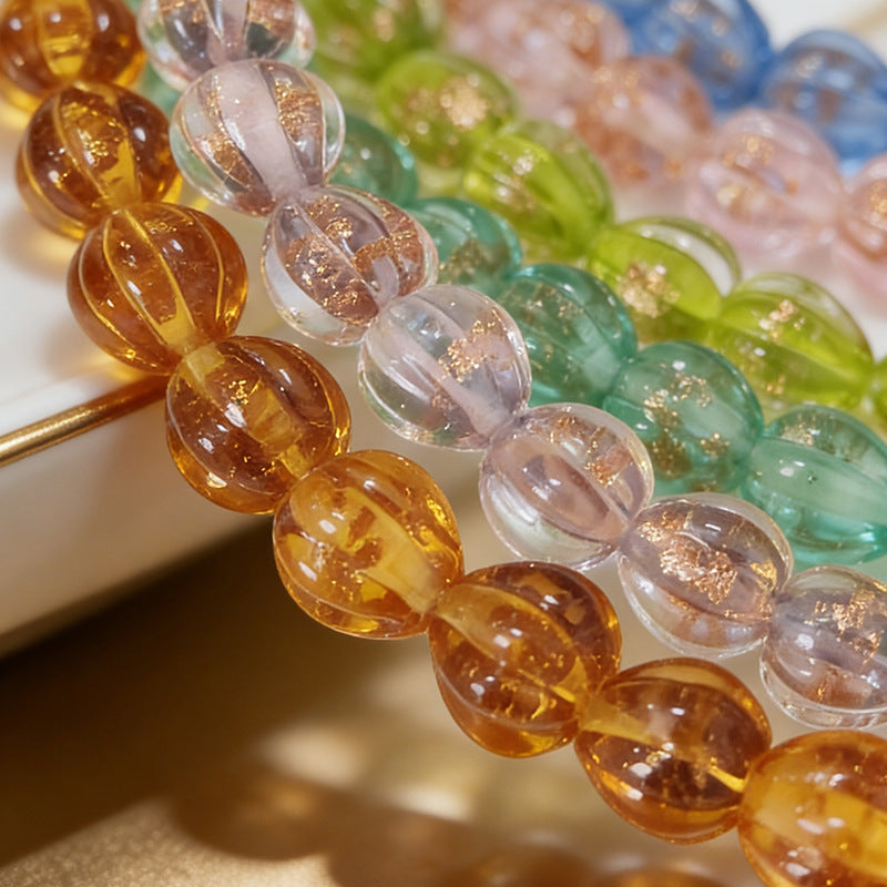 Close-up of translucent gold-sand lantern glass beads in assorted colors