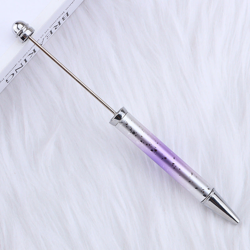 Metallic ombre beadable pen with gradient design on a white fabric background.