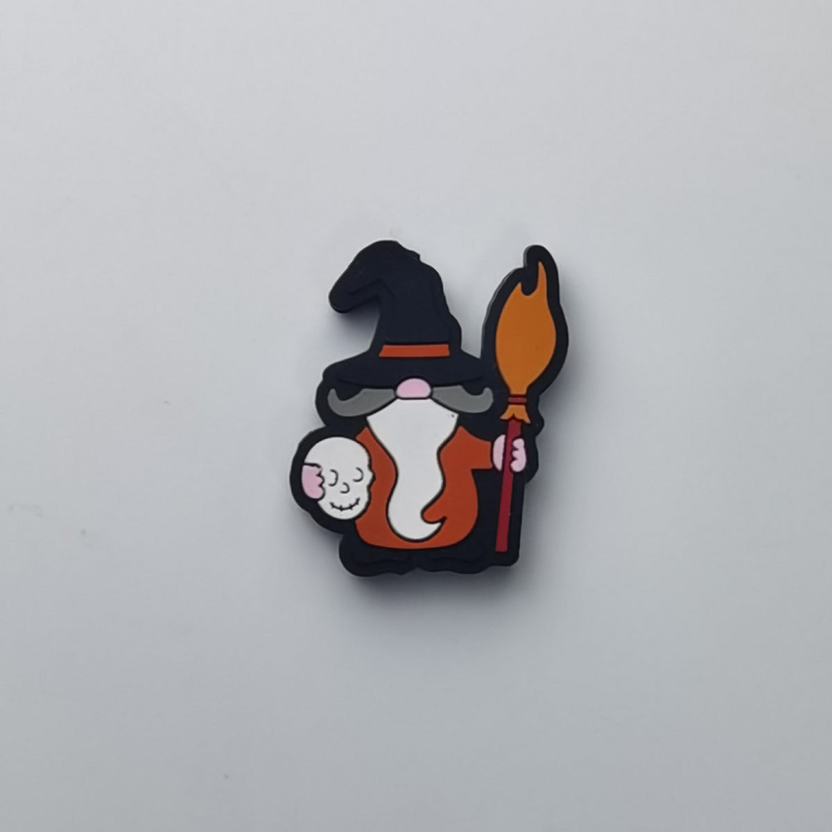 Cartoon witch silicone focal bead with black hat, orange robe, white beard, pink face, and broom