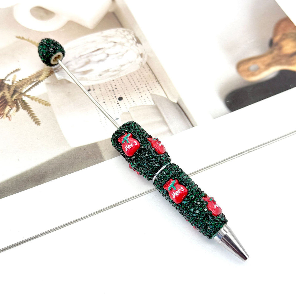 Green rhinestone ballpoint pen with red Santa design.
