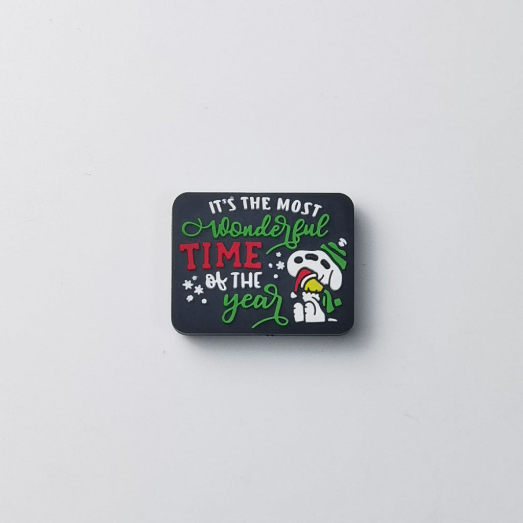 Square black silicone focal bead with 'IT'S THE MOST Wonderful TIME of THE year' text and cartoon dog in green Santa hat