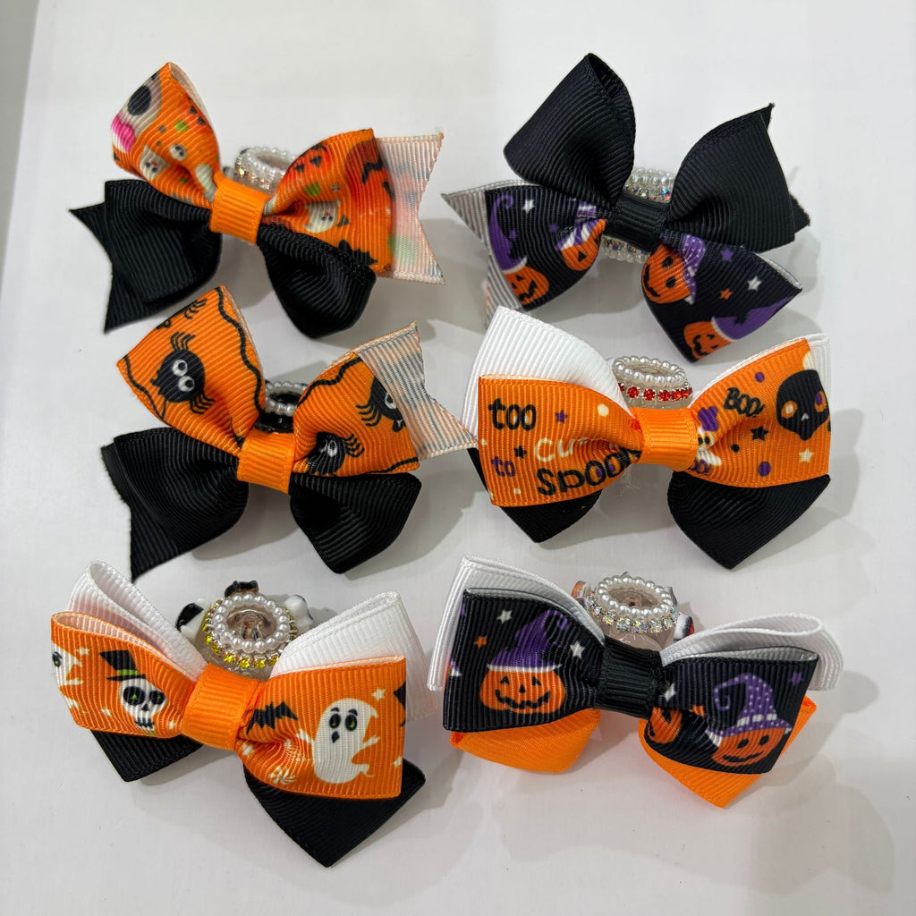 Six Halloween ribbon bow focal beads in orange and black on a white background