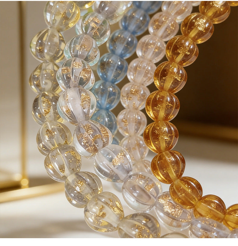 Several beaded bracelets with translucent lantern glass beads in overlapping loops