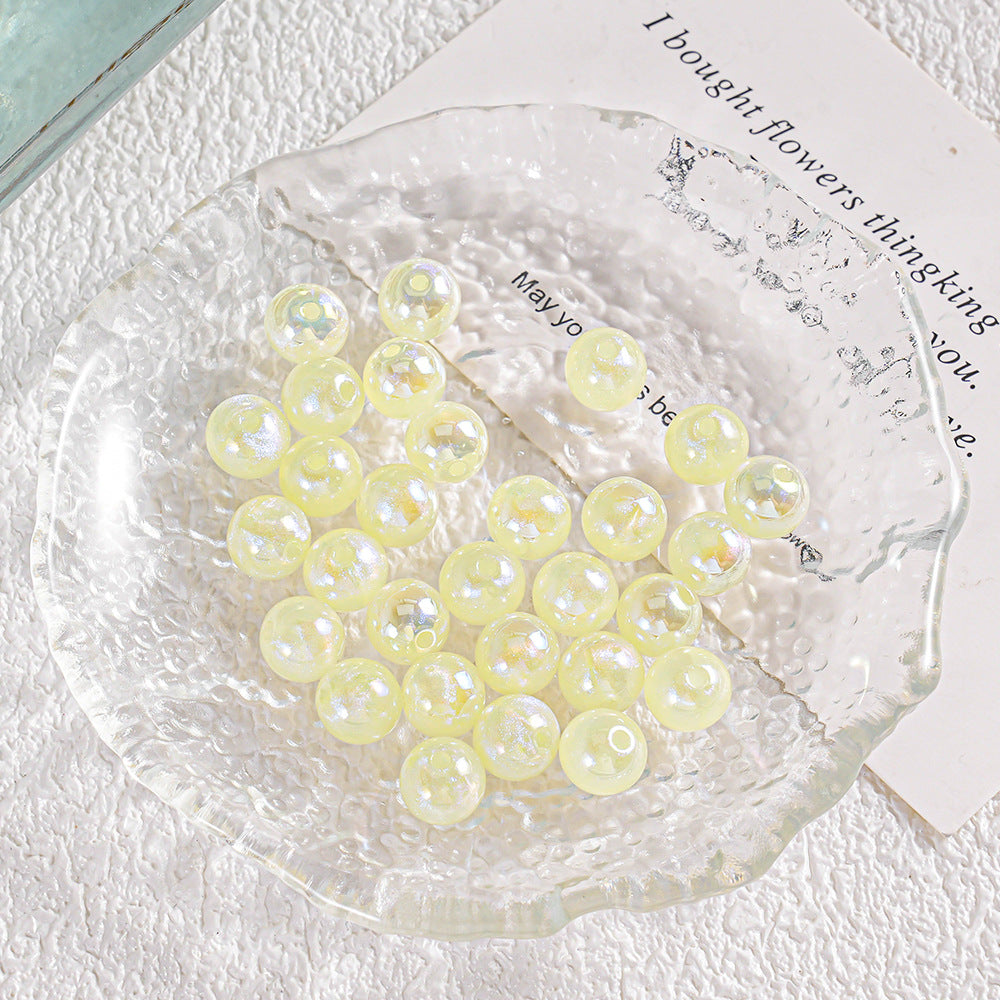 Group of round pale yellow translucent beads with iridescent highlights