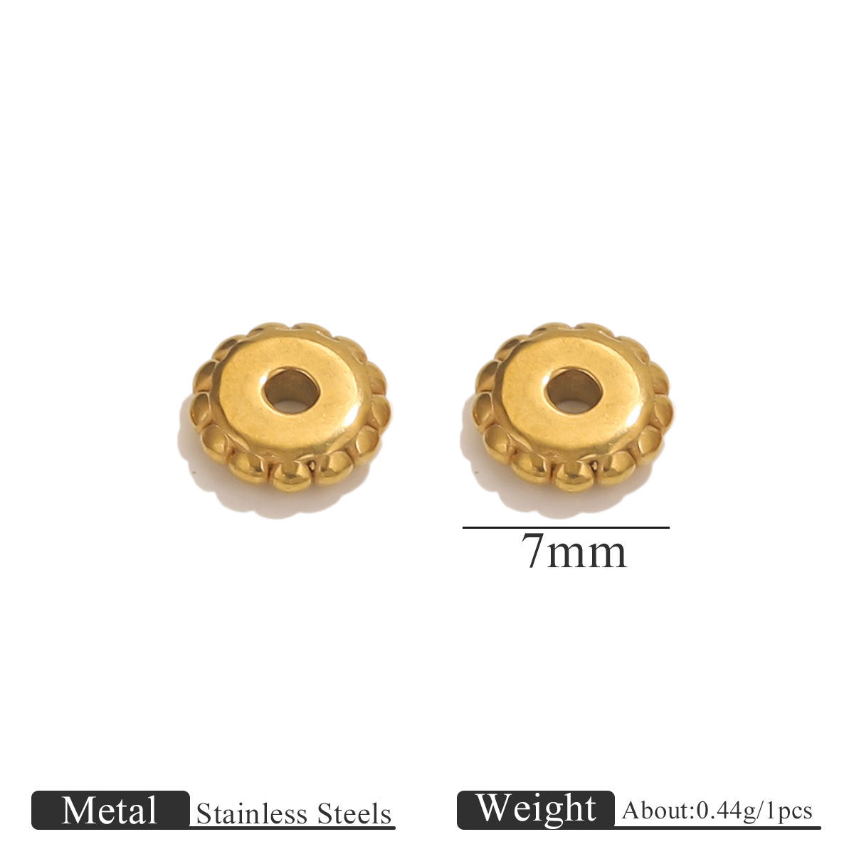 Two small gold-plated dotted gear wheel stainless steel spacer beads with scalloped edges and central holes on white