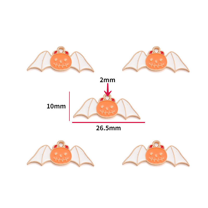 Five bat charms with orange pumpkin faces, white wings and gold outline, 10mm by 26.5mm
