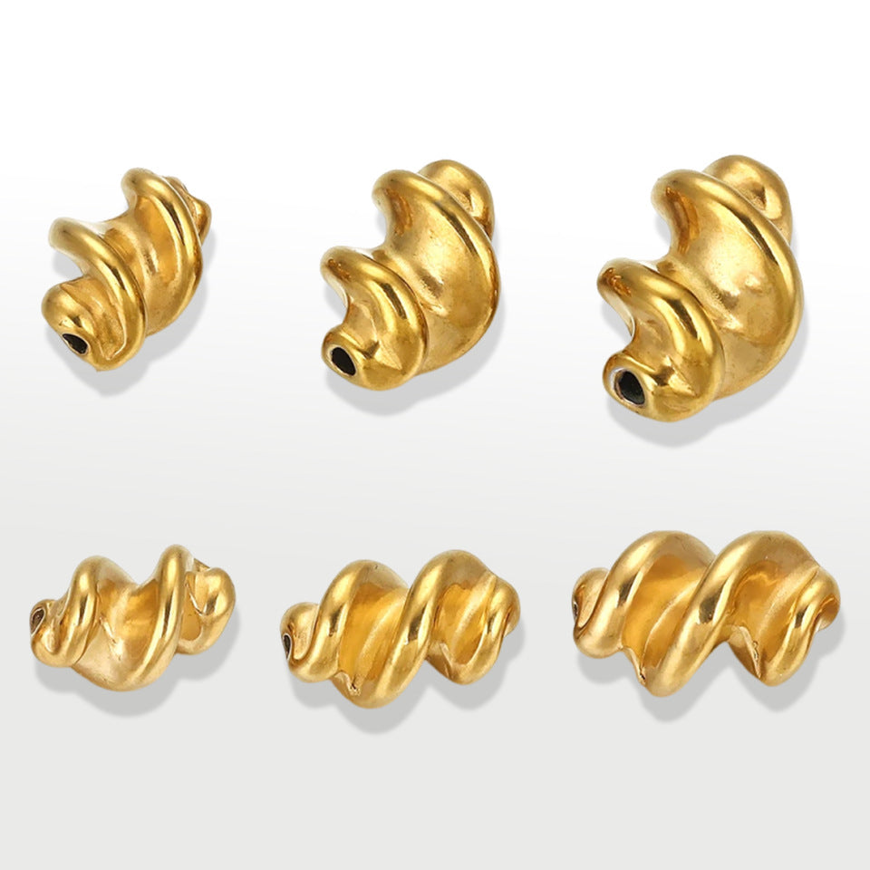 Six gold twisted spiral stainless steel spacer beads on white background