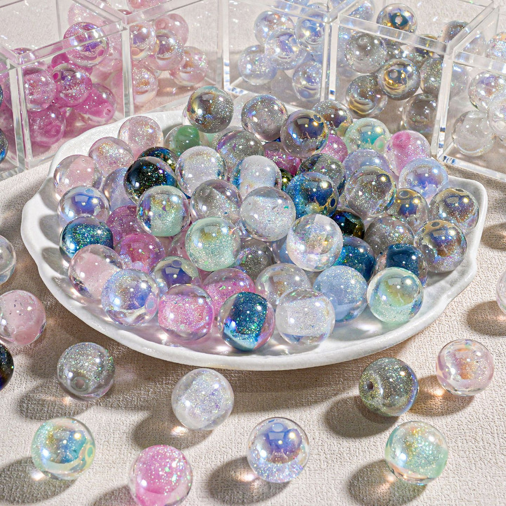 White plate piled with iridescent candy-core opal-effect resin round beads in pastel rainbow colors