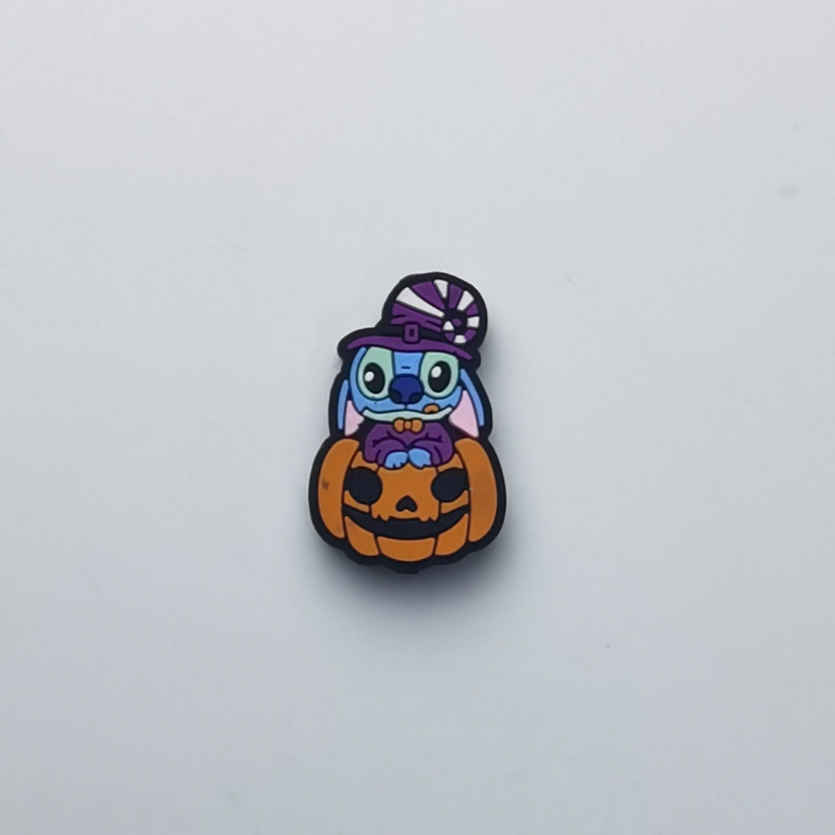 Blue cartoon character bead with witch hat sitting on pumpkin