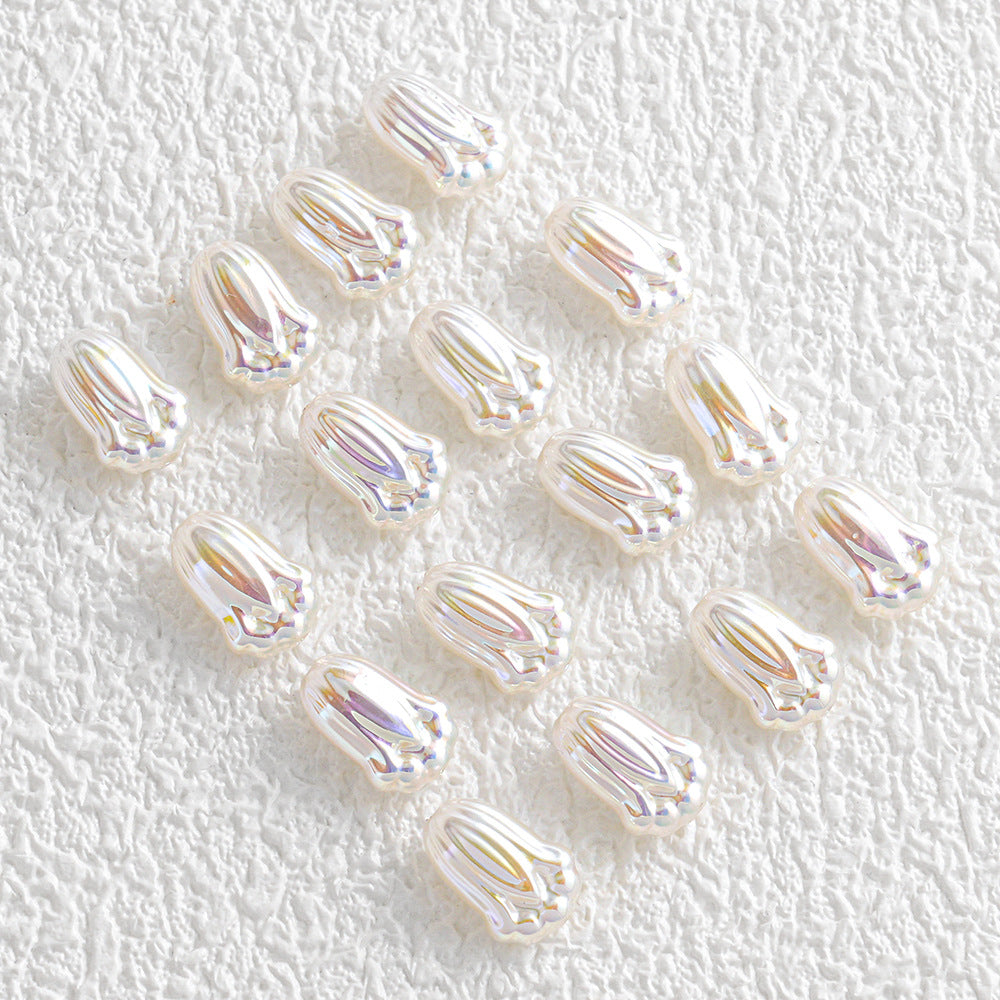 Small iridescent teardrop-shaped faux pearl beads on a textured white background