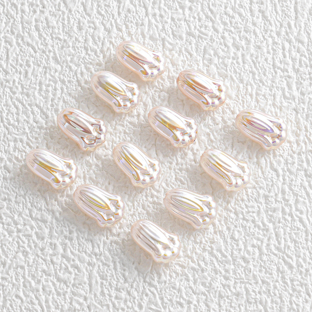Twelve small glossy iridescent shell-shaped beads in a loose cluster on white