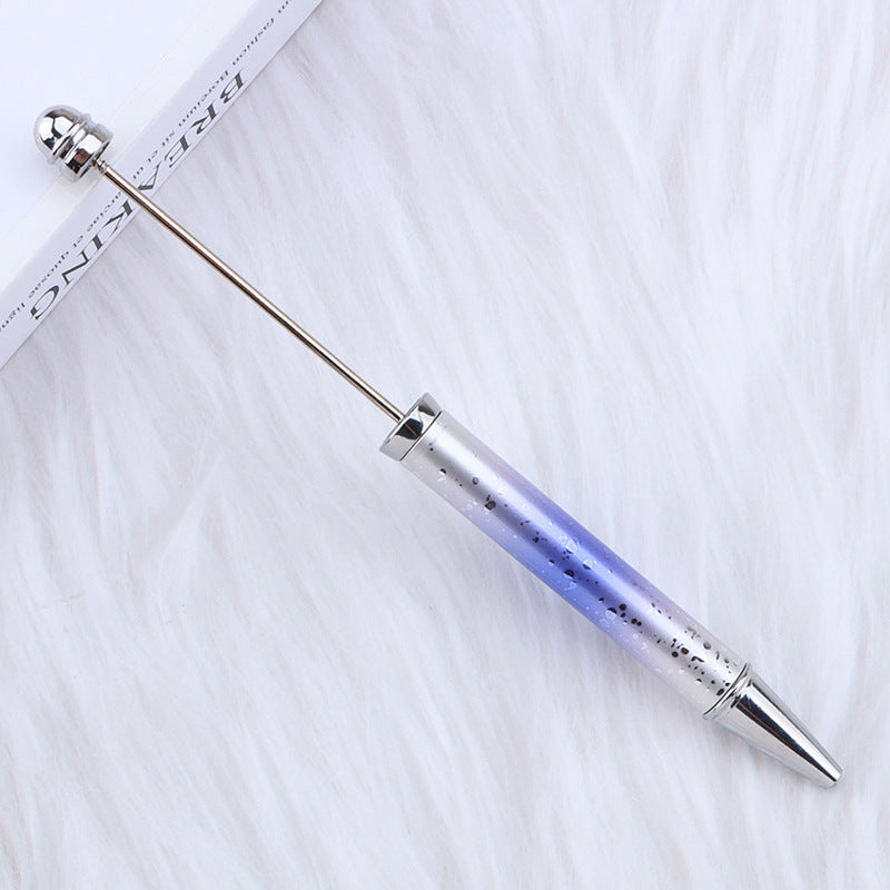Gradient-colored ombre beadable pen with metallic ends on a white background.