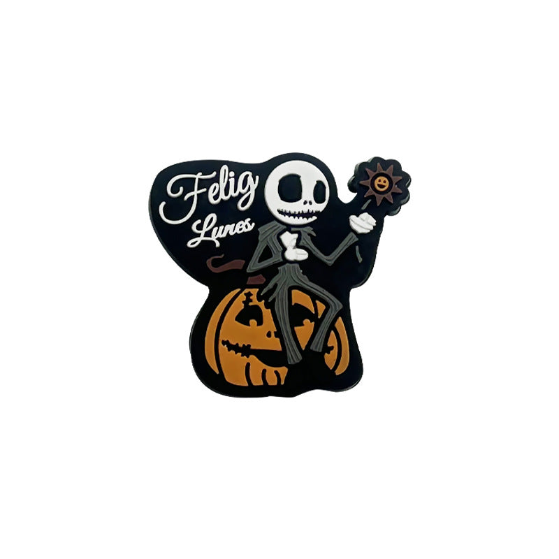 Skeleton character sitting on an orange pumpkin holding a flower with Feliz Lunes text, black Halloween silicone focal bead.