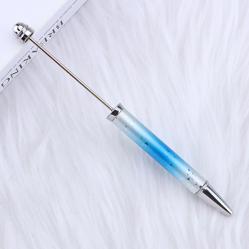 Beadable pen with long silver rod and translucent blue-to-clear gradient barrel.