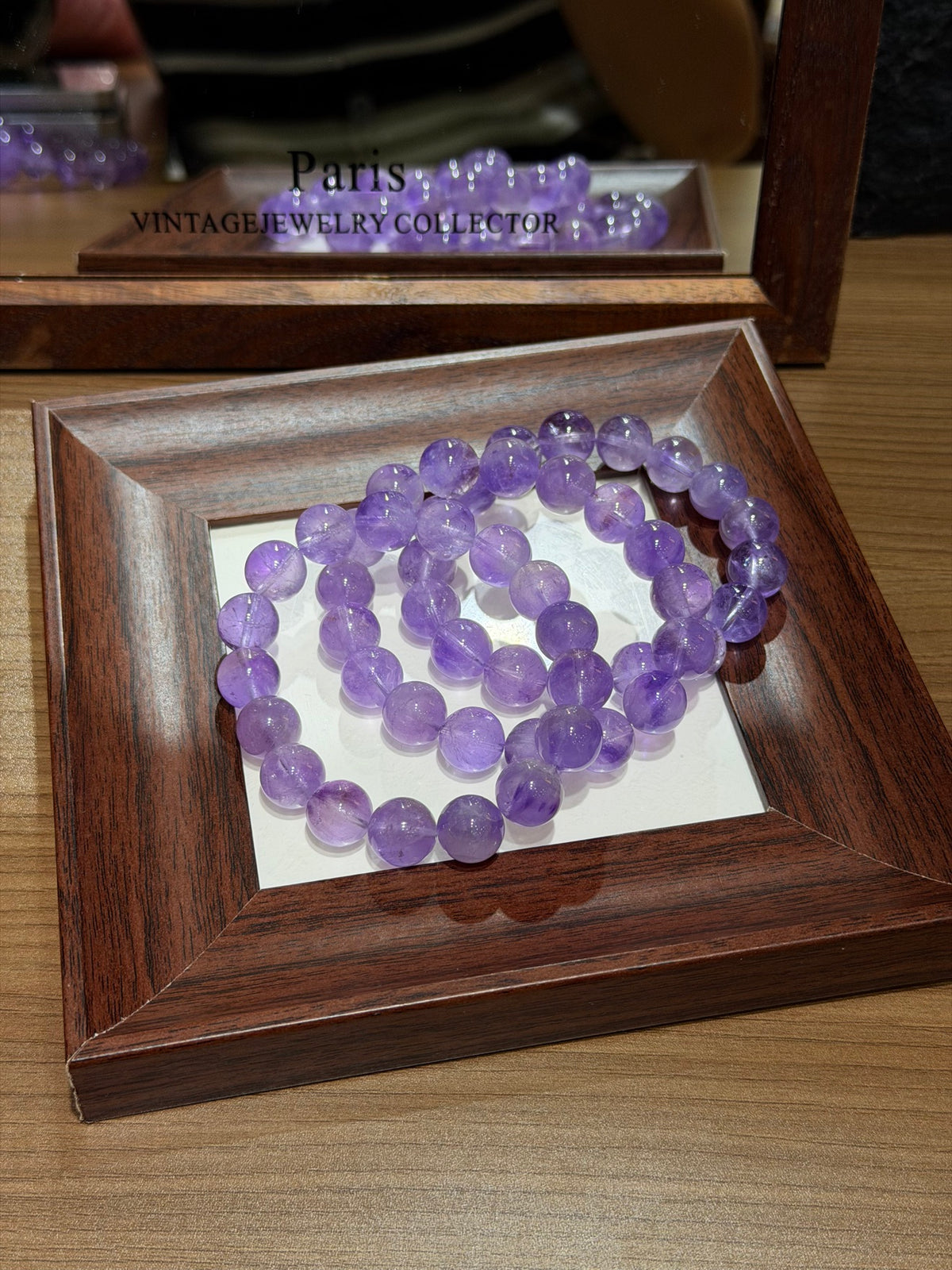 Premium lavender amethyst bracelet coiled on mirror tray