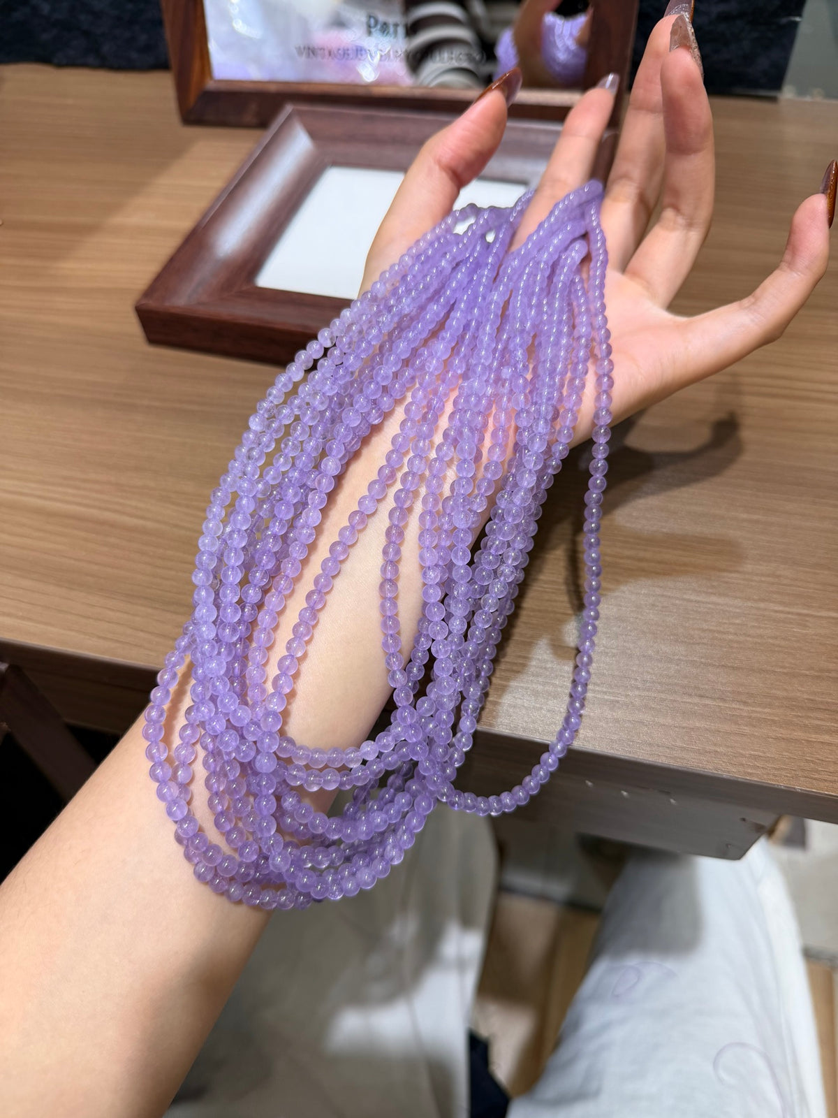 Lavender amethyst triple wrap bracelet strands draped over hand