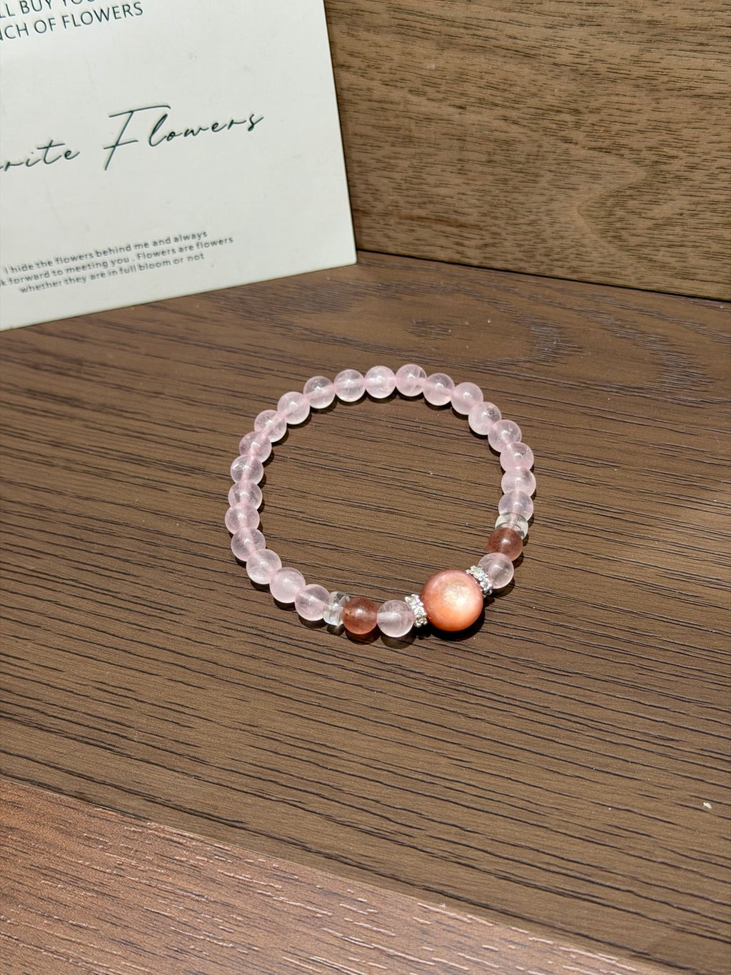 Pink gummy bracelet with strawberry quartz on table