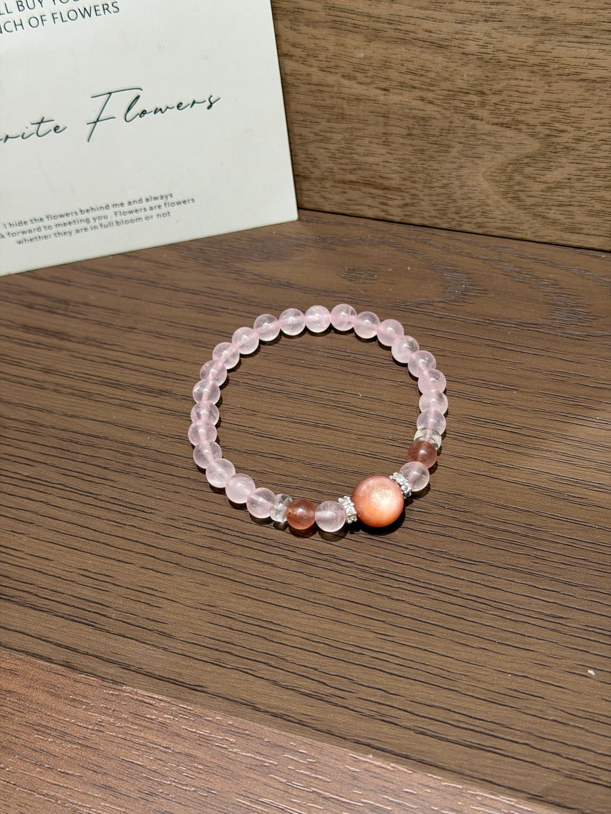 Pink gummy bracelet with strawberry quartz on table