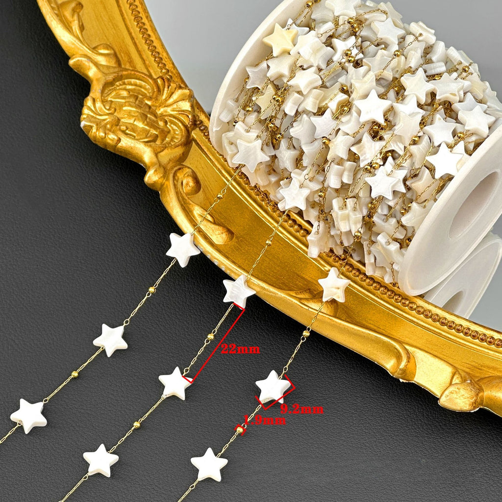 Spool of white star bead chain draped over an ornate gold frame with red dimension markings