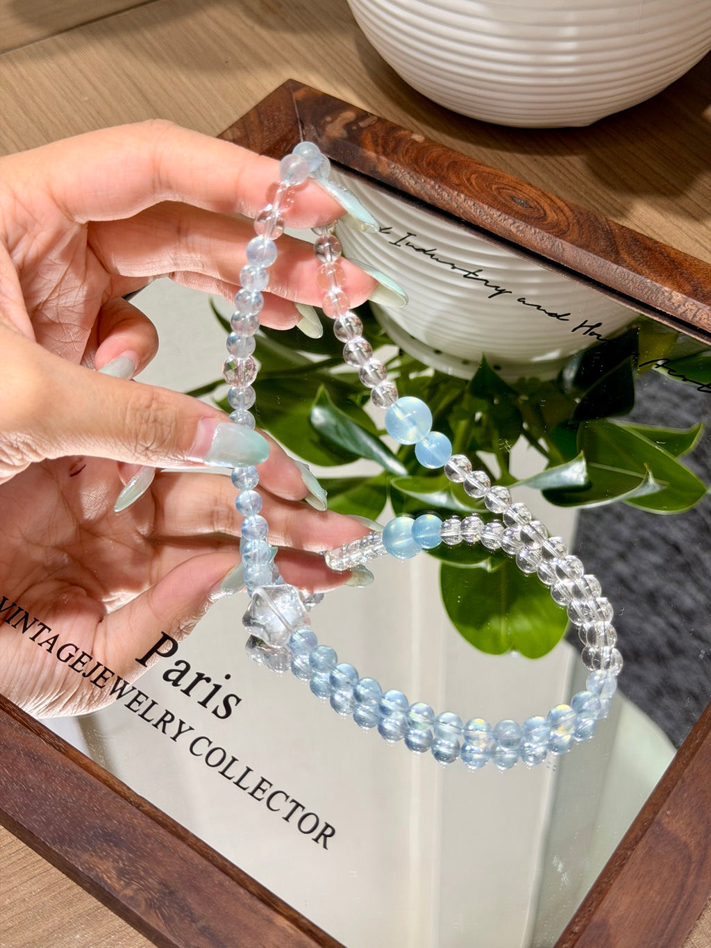 Ocean Starfall double-loop bracelet laid flat showing aquamarine and faceted white quartz