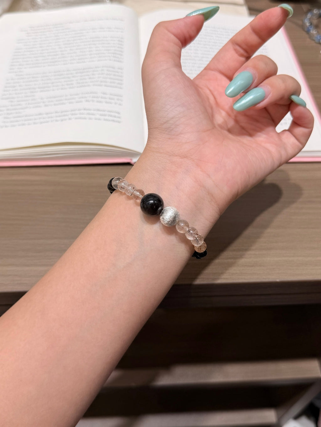 Midnight silk black gold super seven and silver obsidian bracelet worn on wrist