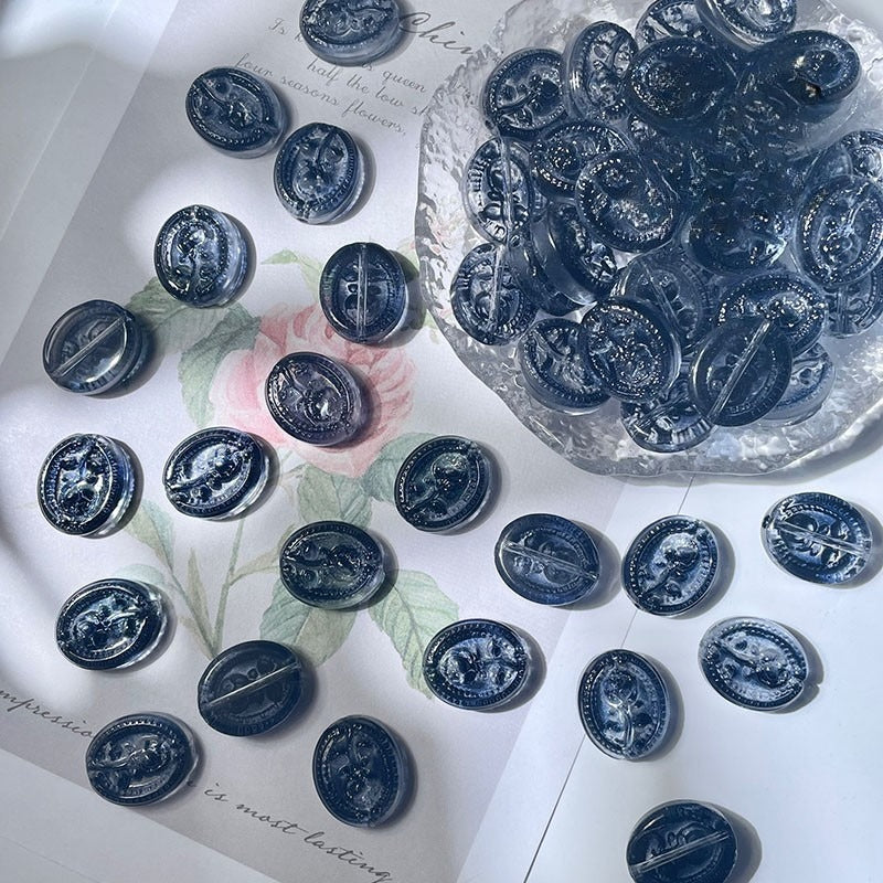 Round dark blue engraved glass rose beads with silver designs on white