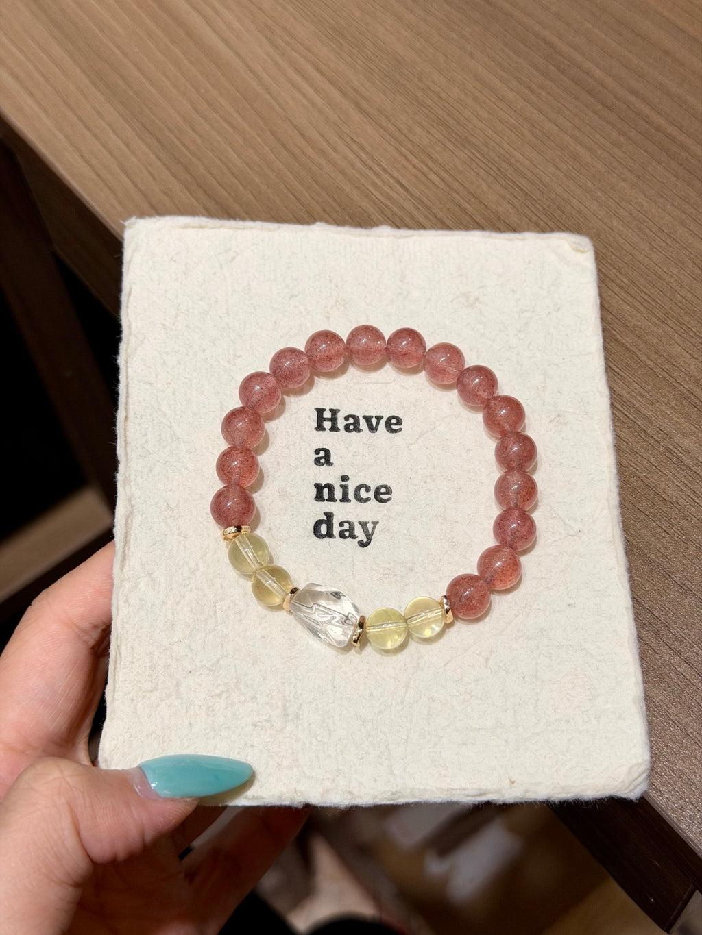 Strawberry quartz bracelet with freeform white crystal on table