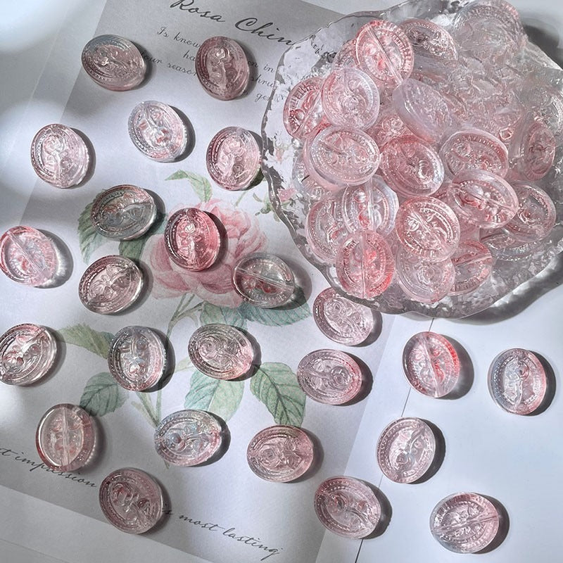 Round clear engraved glass beads with pink and rose-gold accents