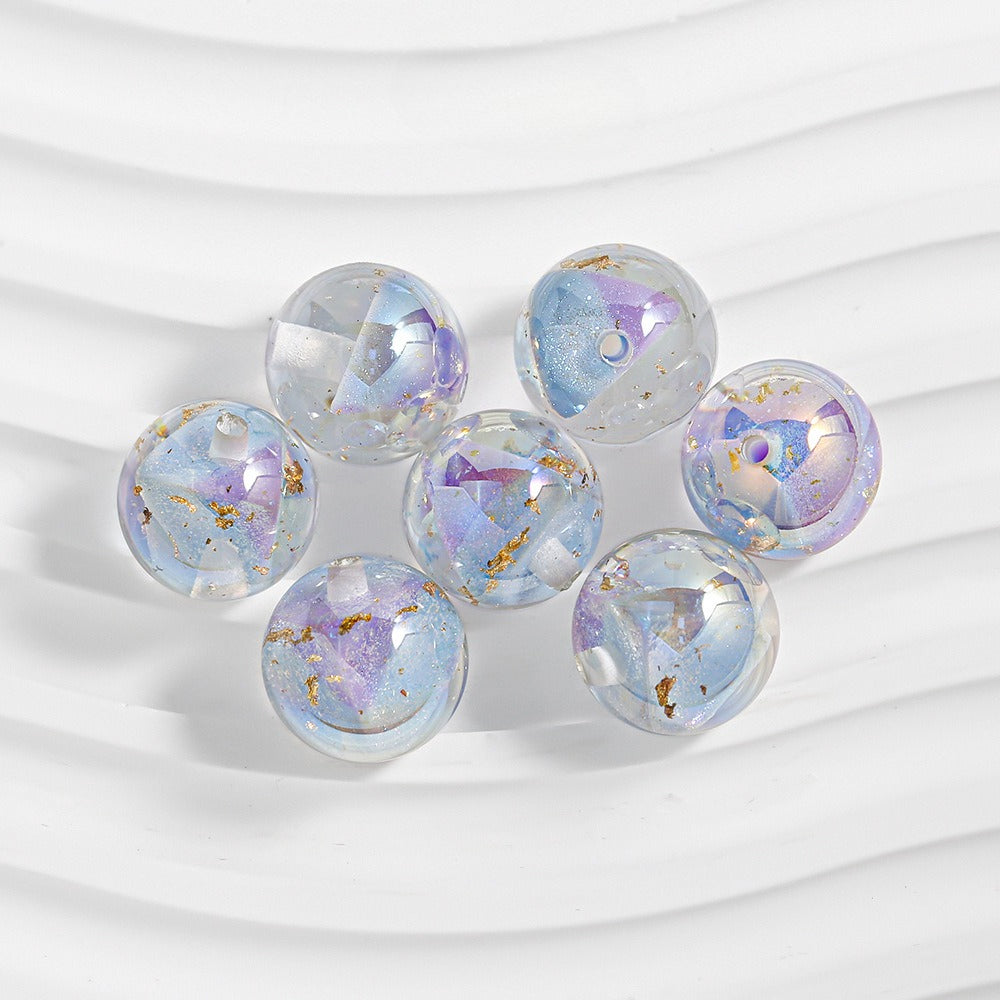 Seven iridescent resin beads with gold foil flakes
