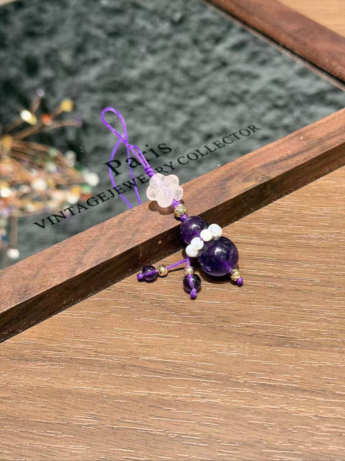 Amethyst fortune gourd charm hanging over card