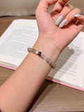 Milky mist milk tea moonstone bracelet with smoky quartz accent worn on wrist