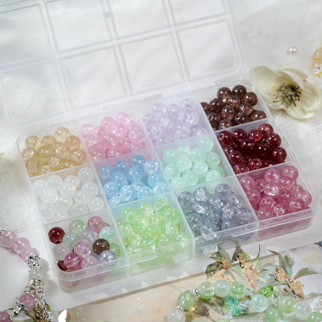 Compartment box of pastel translucent glass round beads in assorted colors
