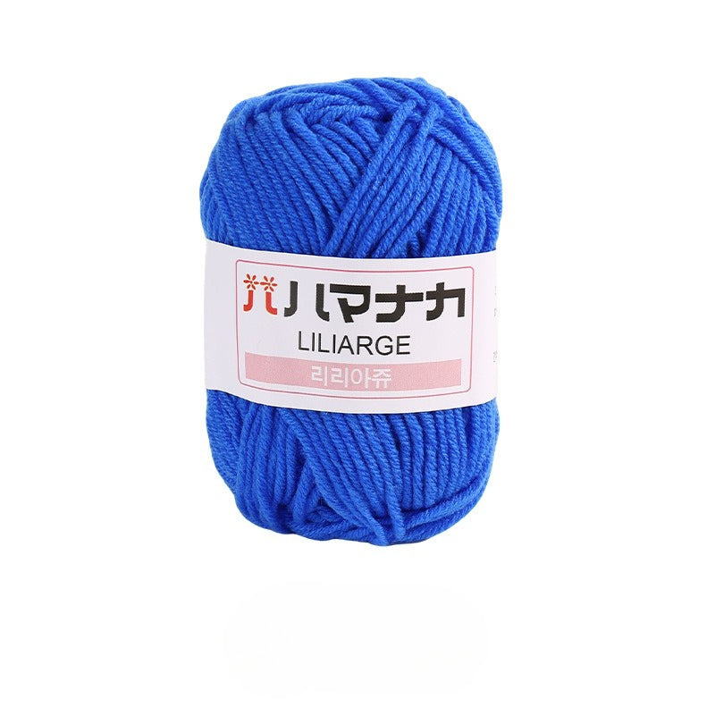 Sapphire blue 4-ply milk cotton-acrylic yarn skein with white LILIARGE label on white background