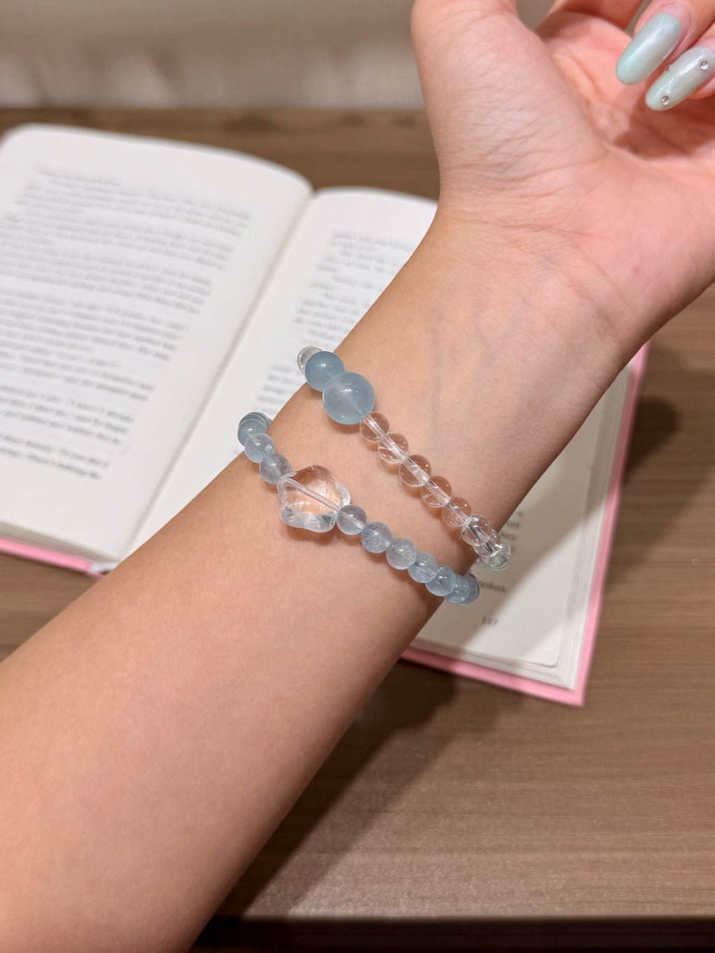 Ocean Starfall bracelet with white quartz star charm resting on a book