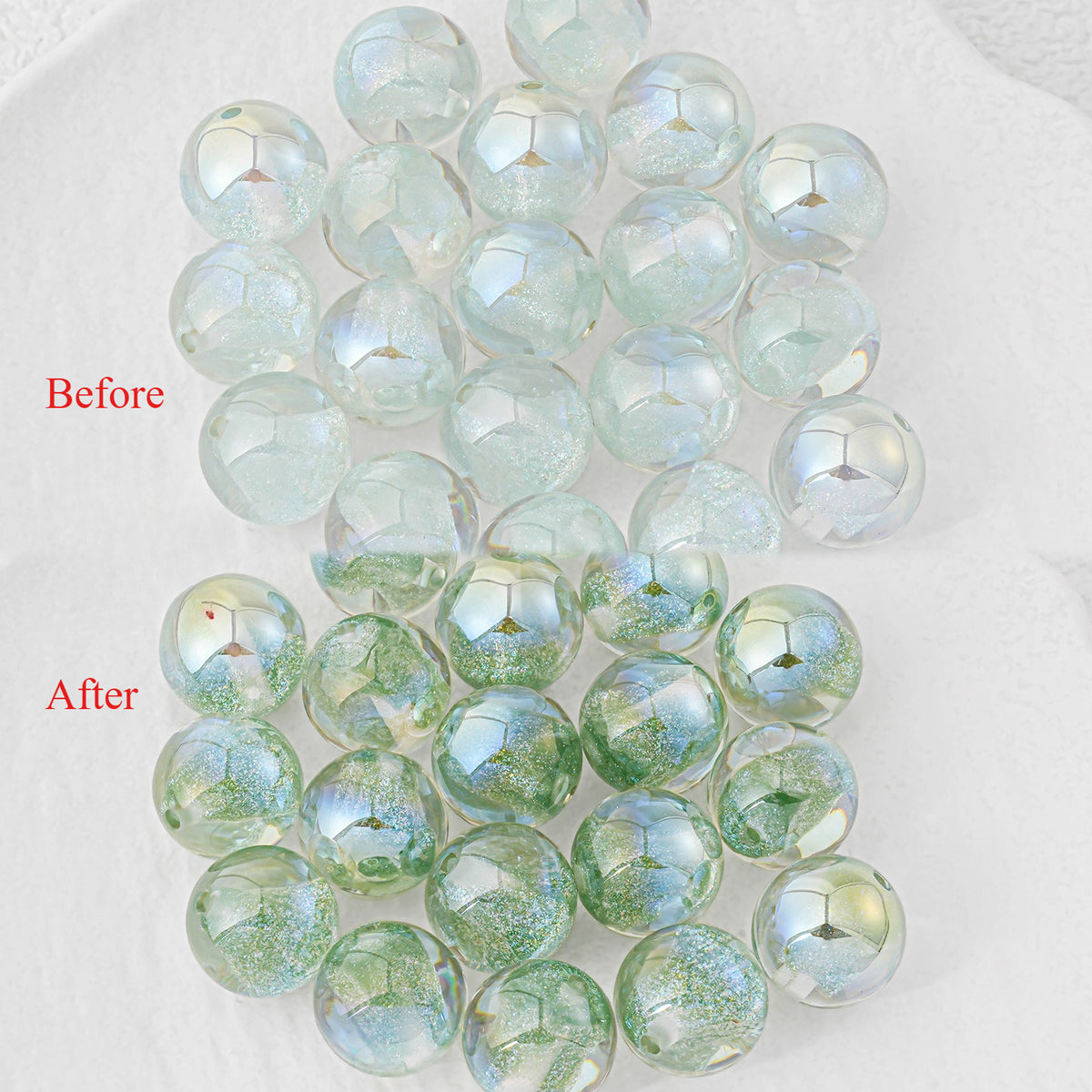 Round iridescent resin beads, before-and-after on white: clear pale blue-green, and green glitter flecks inside.