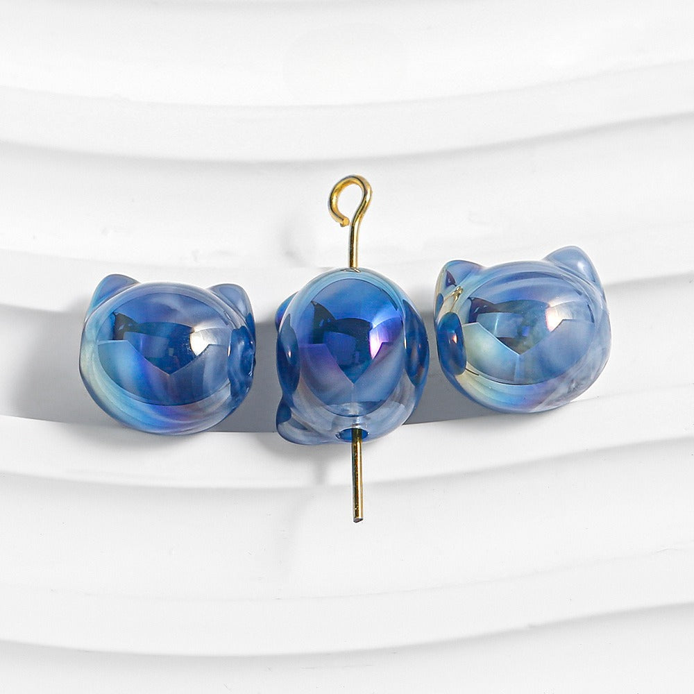 Three blue cat-shaped hair claw clips with iridescent finish and gold metal hooks.