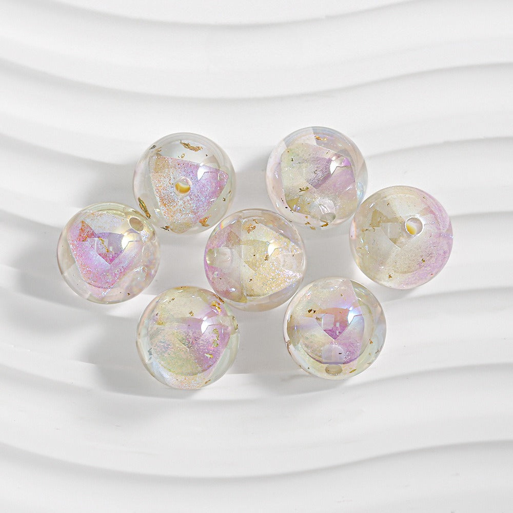Seven transparent resin beads with iridescent pastel pink and gold finish