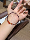 Purple garnet and carnelian bracelet set worn on a wrist
