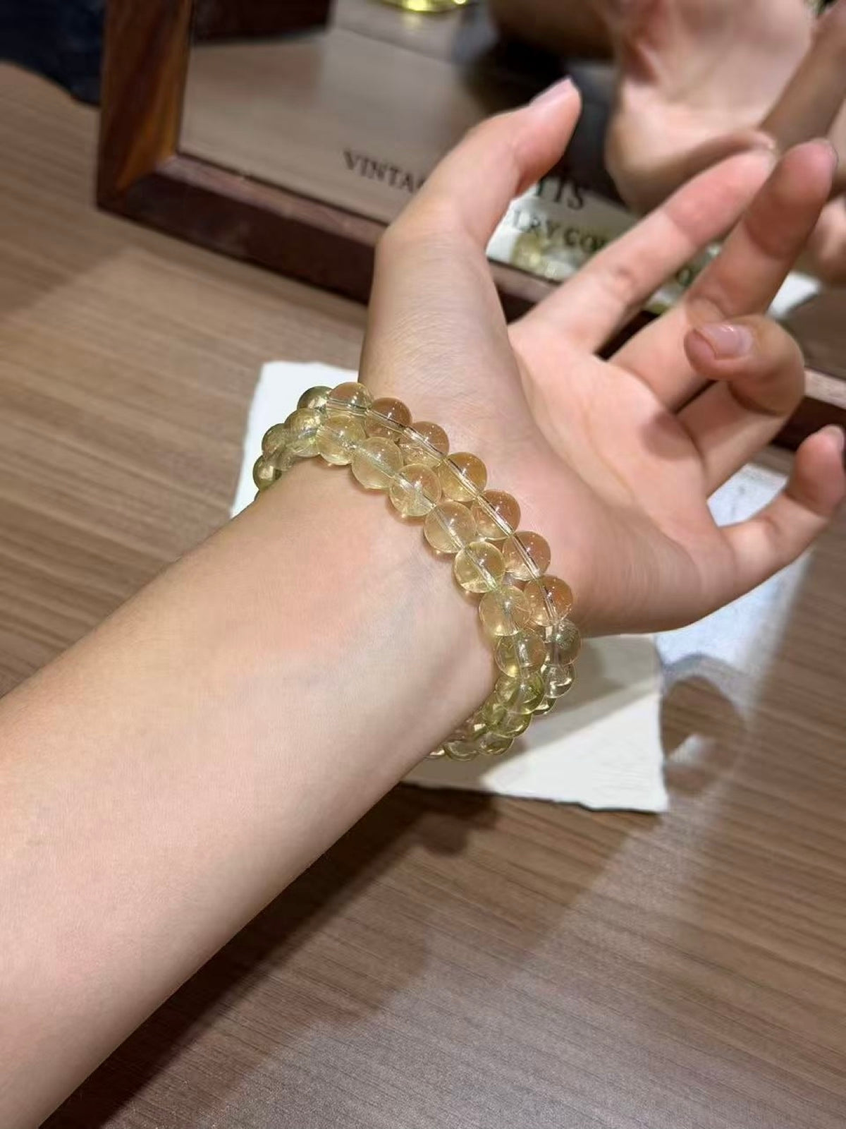Lemon citrine plain strand bracelets laid on a Thank You card