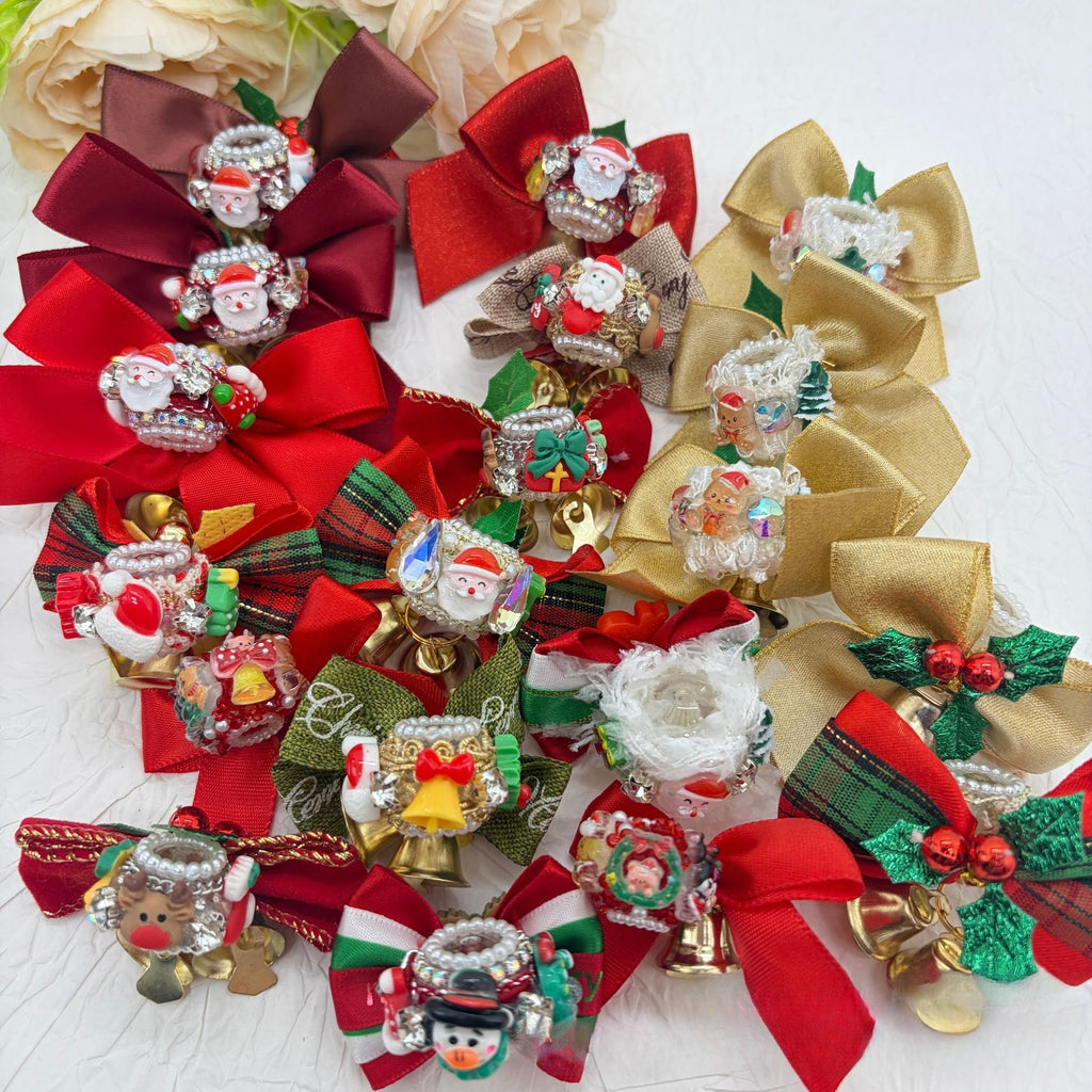 Large collection of Christmas bow focal beads with Santa figurines, bells, holly, and festive ribbons.