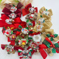 Large collection of Christmas bow focal beads with Santa figurines, bells, holly, and festive ribbons.
