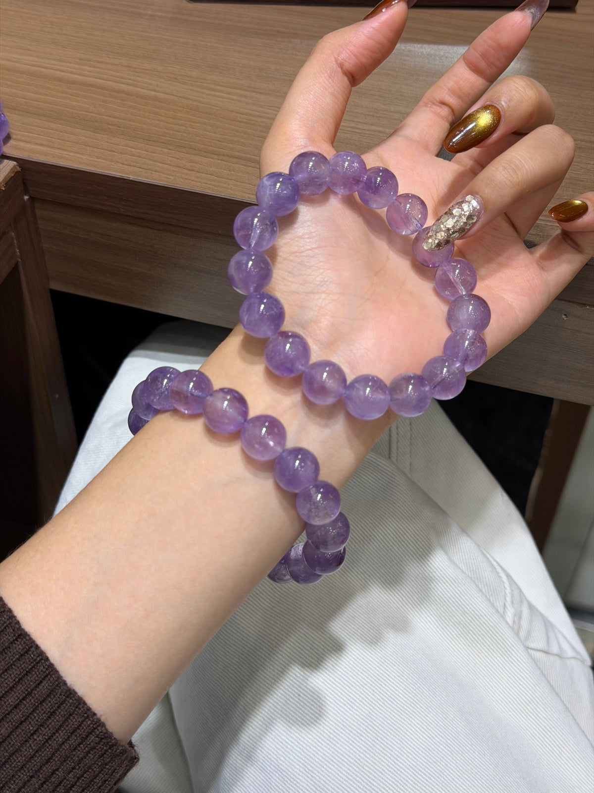 Premium lavender amethyst bracelet with 12.6mm beads worn on wrist