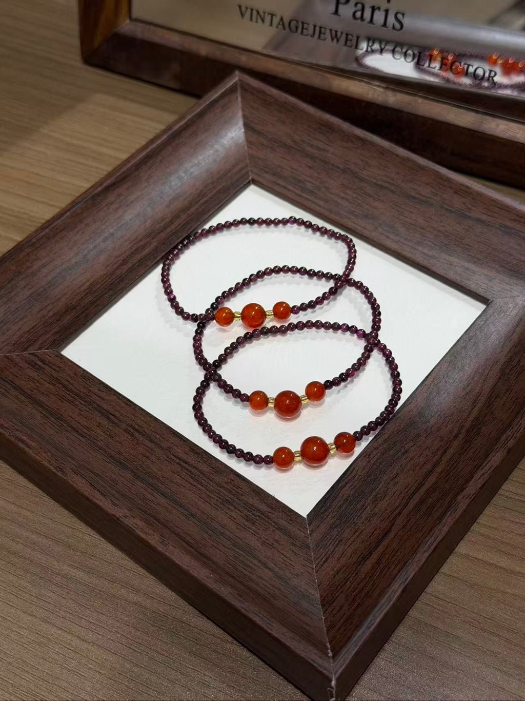 Purple garnet and carnelian bracelet set coiled on a tray