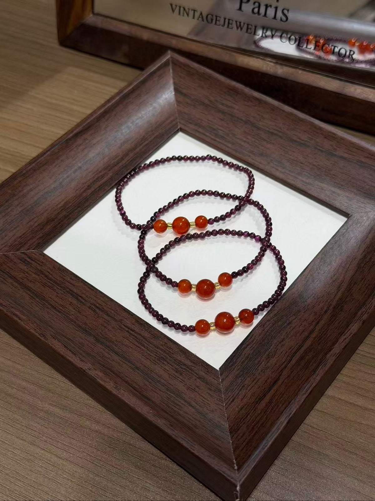 Purple garnet and carnelian bracelet set coiled on a tray