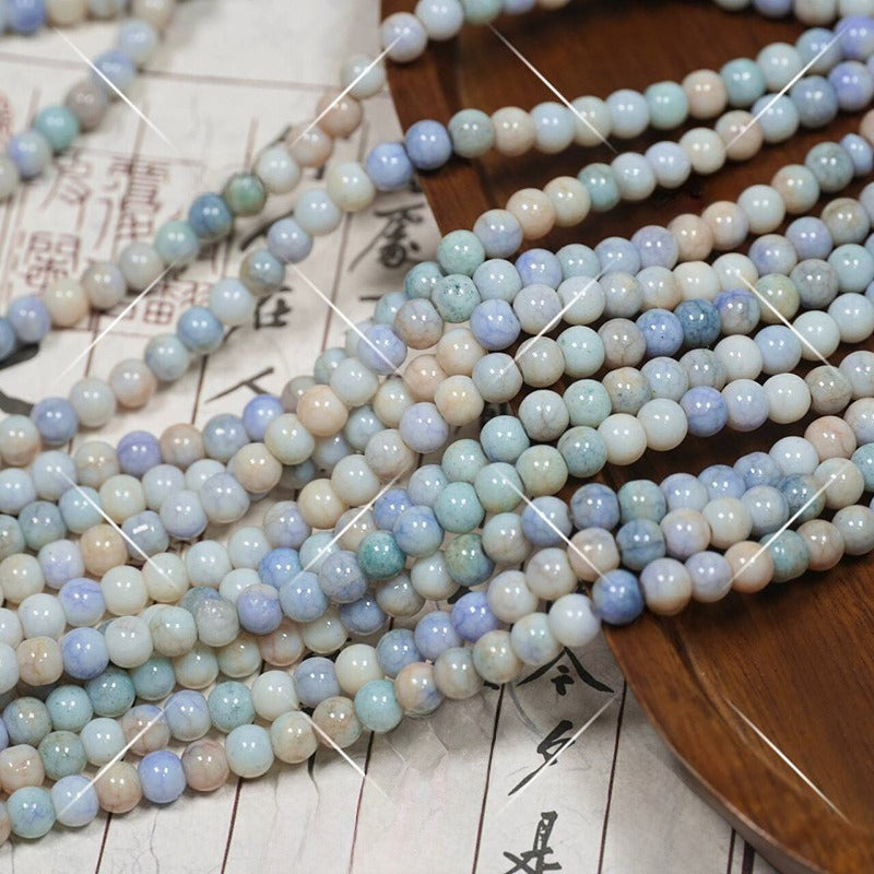 Multiple strands of pastel round porcelain beads in blue, green, beige, white