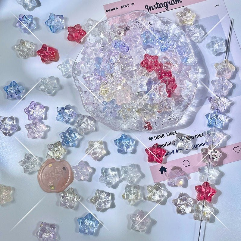 Glazed glass star-shaped beads in clear, light blue, pink, and red