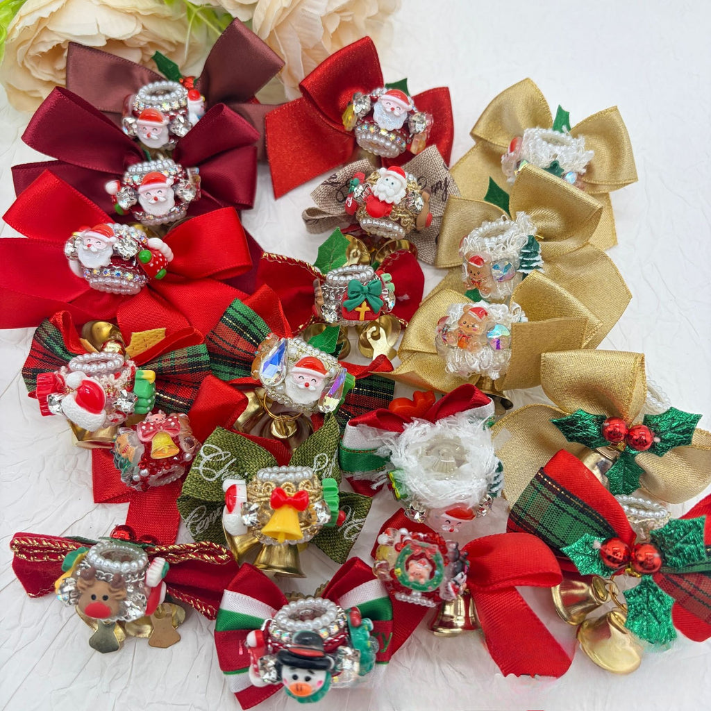 Assorted Christmas bow focal beads with red, gold, green, and brown ribbons, Santa figures, snowmen, and bells.